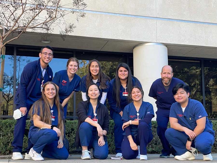 Nursing students in blue scrubs
